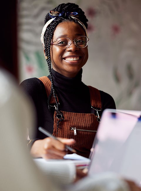 woman-smiling-higher-education-computer-studying woman-smiling-higher-education-computer-studying
