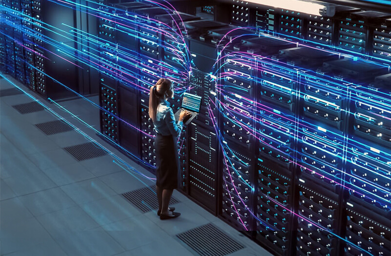 Data center engineer in a modern data center surrounded by activity