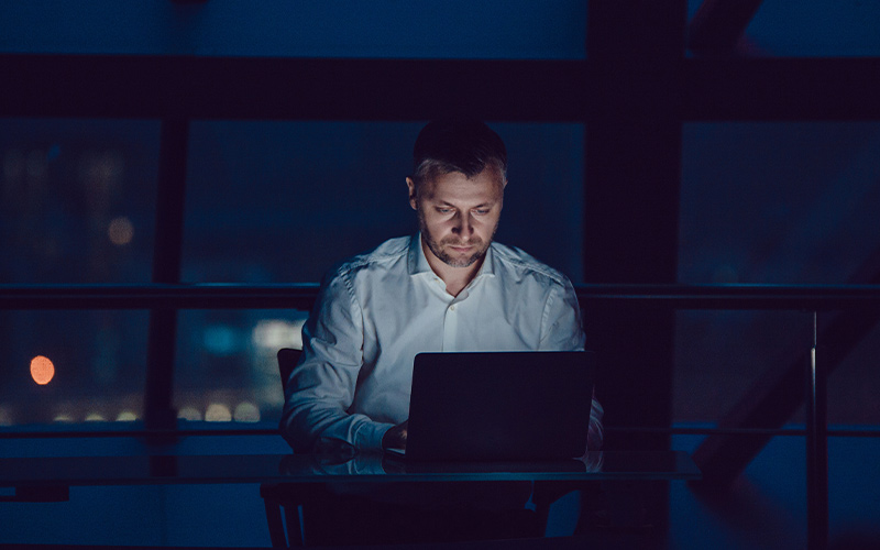 Man working on a laptop at night
