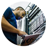IT professional looking over servers in data center