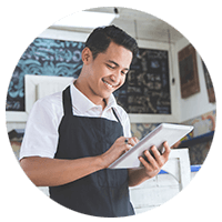 Store owner happy looking at tablet device