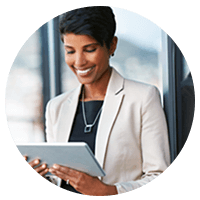 Smiling businesswoman holding tablet device outside