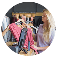 Woman purchasing shirt in retail store