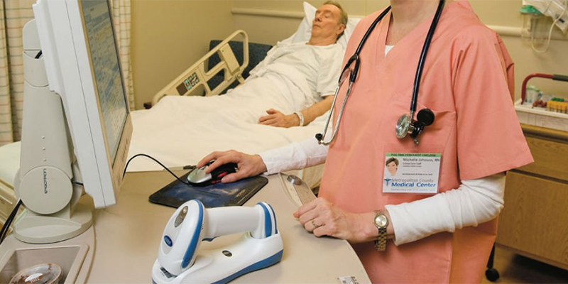 Nurse using Zebra barcode scanner with patient in emergency room