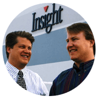 Tim and Eric Crown standing in front of an early Insight corporate office