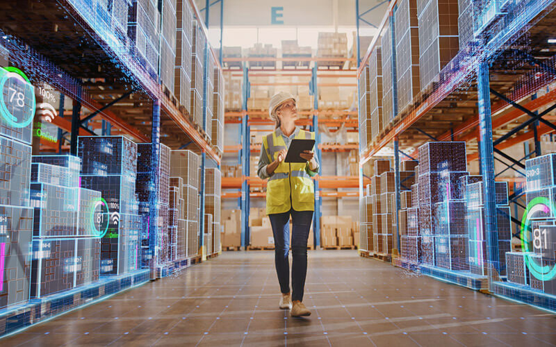 Next-gen technology professional reviewing AI data in modern warehouse facility