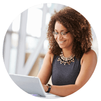 Businesswoman works on laptop in open office