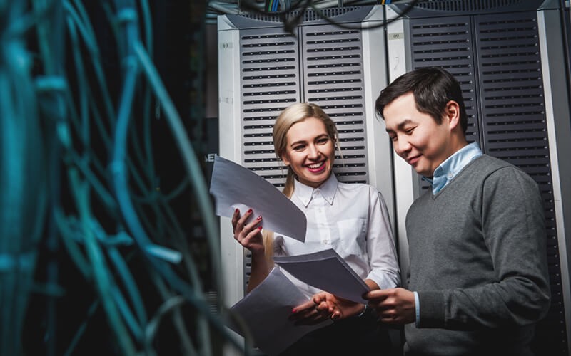 Two IT technicians review data center strategy 