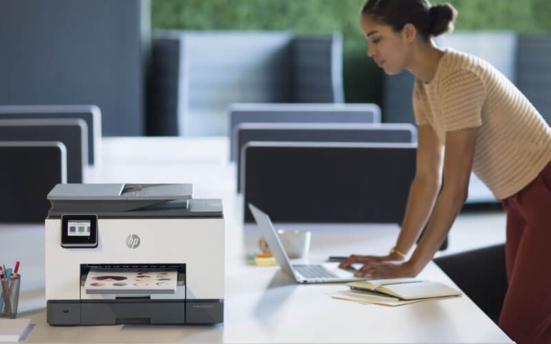 Woman using HP OfficeJet all-in-one-printer in office