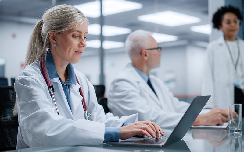 Doctors using laptop