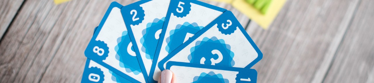 Close up of Scrum Poker cards in hand. Agile development. Agile Planning poker.