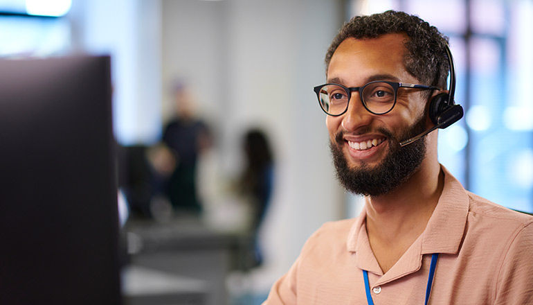 AI momentum that doesn’t stop at the call center Man on headset device