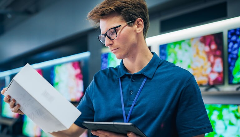 The client needed to enhance operational visibility, and streamline workflows for application, network, and ITSM tools. Sales manager in retail store expertly manages operations using tablet computer