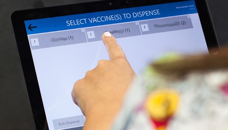 Clinician uses finger to tap on tablet information about vaccines 