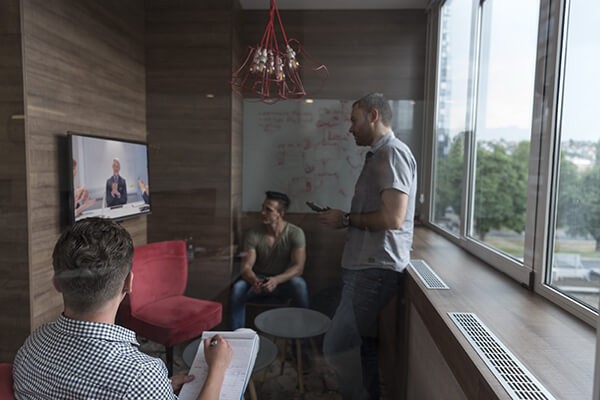 Group of people in business meeting using surface hub