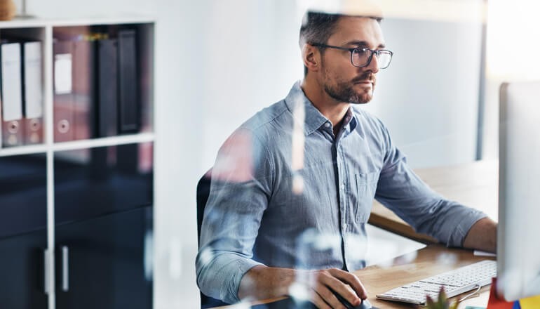 Protecting Your Azure Workloads With Robust Cloud Security webinar Man working on desktop