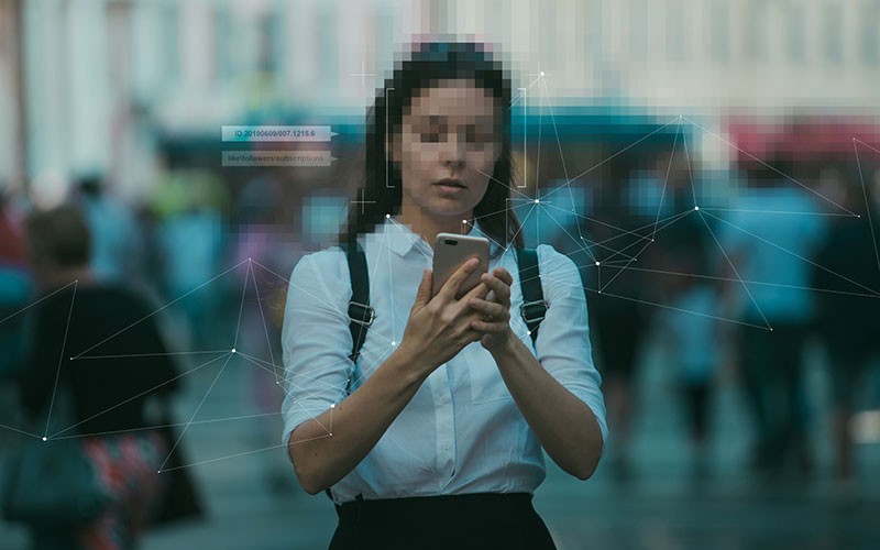 Woman with facial recognition graphic overlay