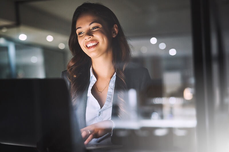 Federal government contracts with Insight Woman smiling while working