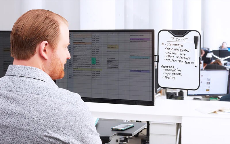 3M’s goal is to help create a work environment that improves your job satisfaction and overall well-being. Man using a monitoe with 3M filter