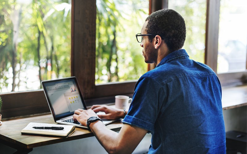 ABBYY Recognition Server transforms large amounts of data into searchable archives Man working on laptop