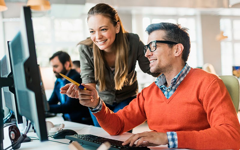 With end-to-end monitoring, organizations can gain a deeper understanding of the threats they face. Man teaching his co-employee