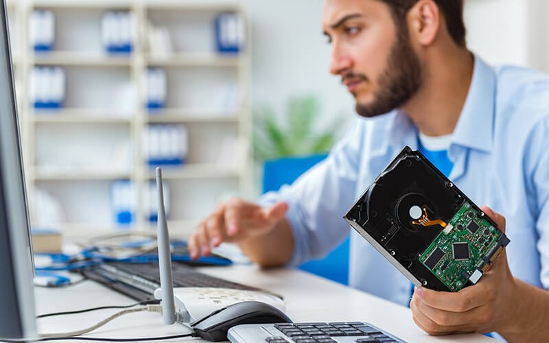 Data destruction Man holding hardware storage