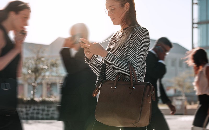 Entrust’s innovative Sigma DS1 and DS2 card printers make issuing physical identification cards Woman using her gadget