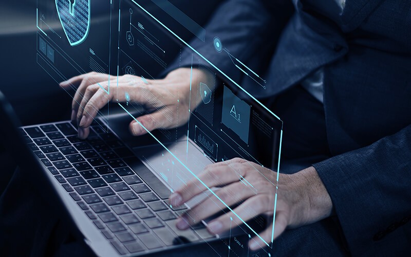 Ironclad cybersecurity protection from Forcepoint Man typing using laptop