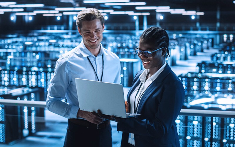 GitLab for GitOps Two person collaborating inside the data center