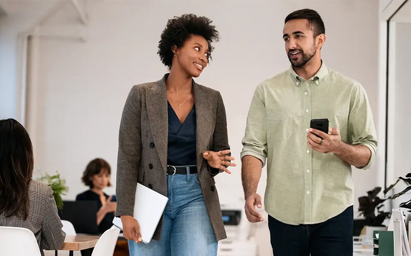 worplace-mobility-android-enterprise_coworkers-walking-with-gadgets-office Two users walking with Anroid devies