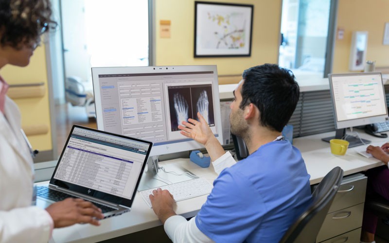 Help you deliver top-notch patient care. Two doctors at nurses station