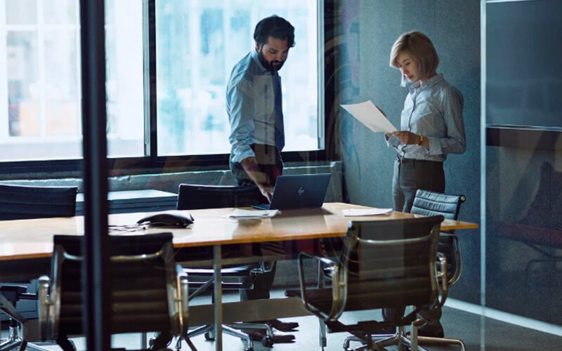 HP Wolf Enterprise Security Teammates working together using a HP laptop