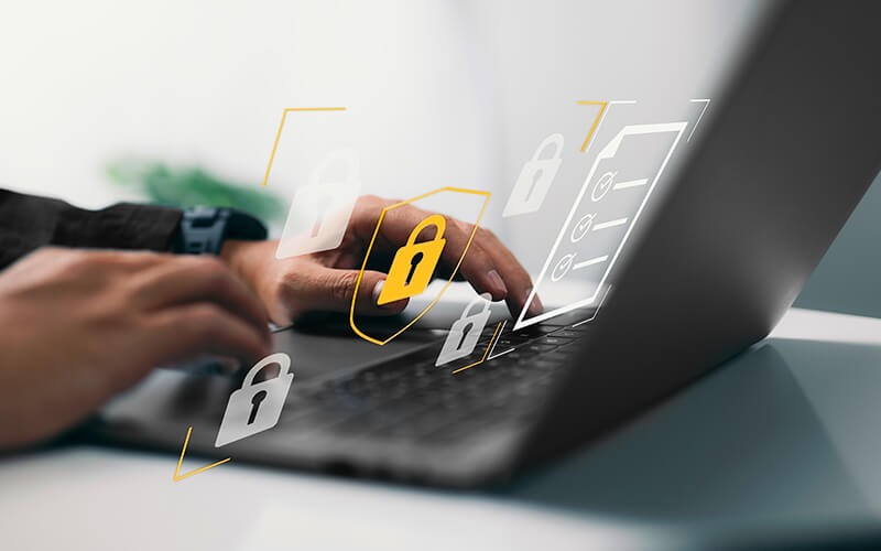 Never compromise endpoint security. Person typing on laptop