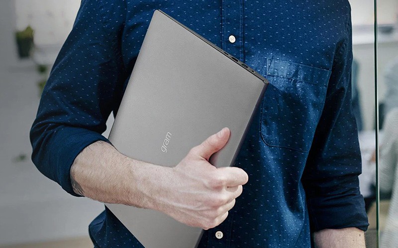 LG makes it easy to boost employee satisfaction. Professional holding a laptop