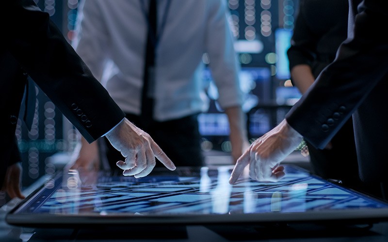 You can reliably scale Agile and DevOps across all your environments Professionals discussing on a glass pane