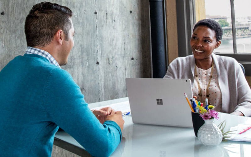 Microsoft Cloud Solution Provider (CSP) program Business professionals in office having a meeting.