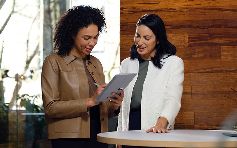 Retail associates need a portable, easy-to-use device that meets the performance requirements Retail associates discussing