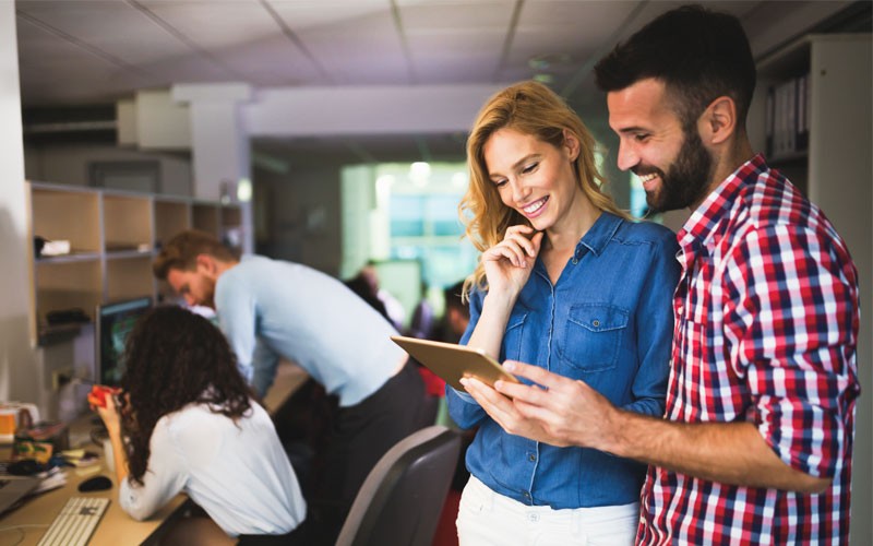 Use cloud storage to maintain control of your data Two employees collaborating over tablet device
