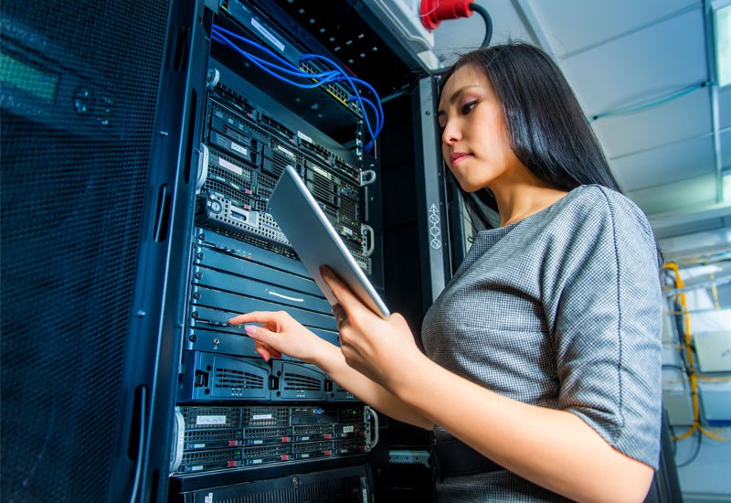 Backup the entire enterprise combining storage, backup, and recovery Woman in database server room on tablet
