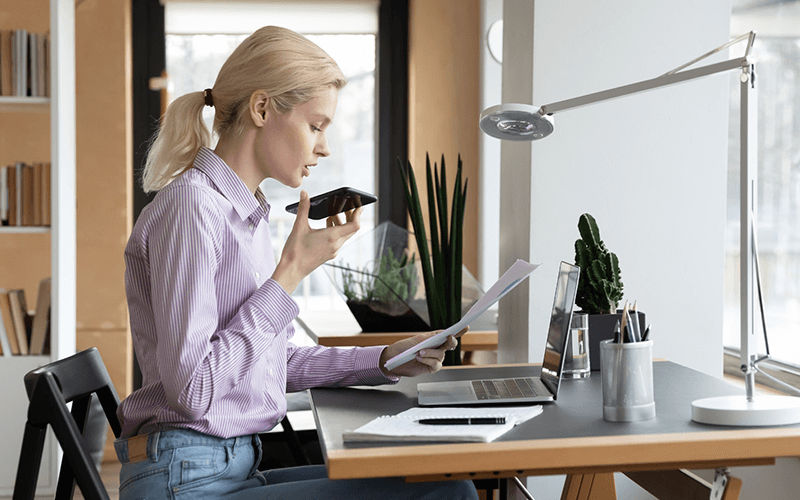 Do more in your day with NextivaONE app Woman talking to someone using a smartphone