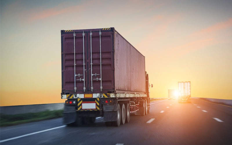 Monitor various features of your fleet Back of truck driving down highway