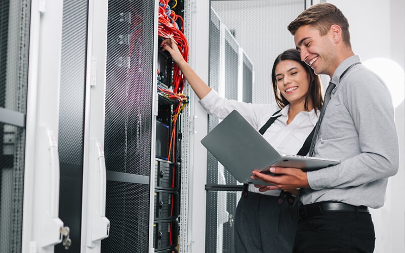 Two employees in server room