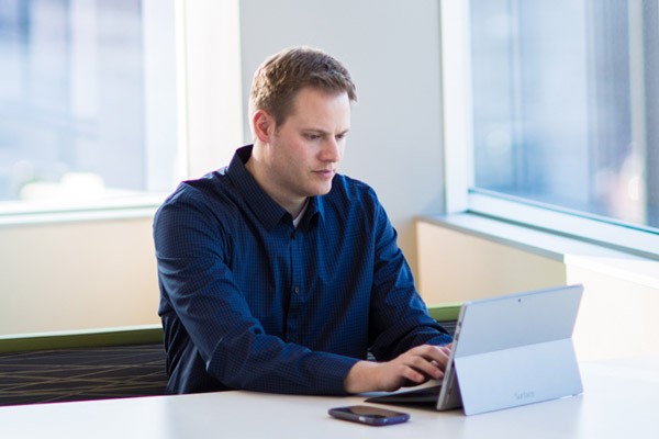 Detect, investigate and respond to advanced threats and manage identities IT administrator using Microsoft Surface Pro with RSA's security portfolio