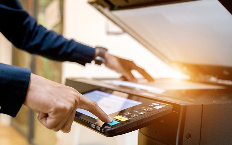 Protect all your printers and scanners Businessman using printer