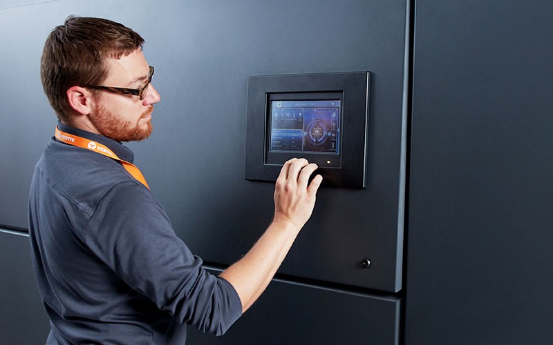 Vertiv employee touching IT system touch screen