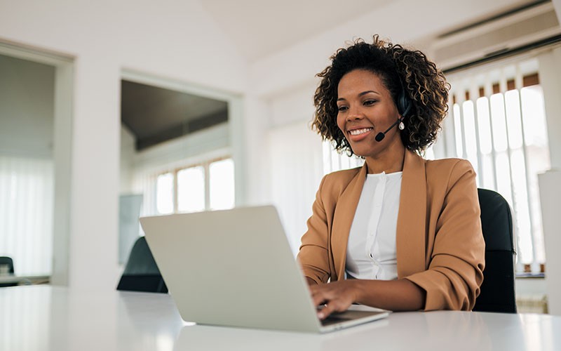 Our team of IT experts will help identify improvement opportunities Help desk support technician with headset on laptop computer