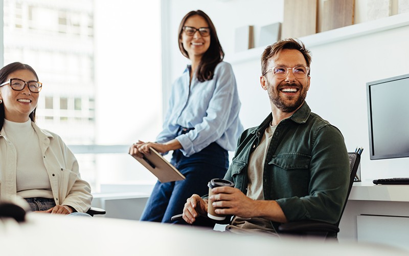 team-discussing-in-office-at-desks team-discussing-in-office-at-desks