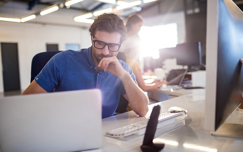 Our experts can help address your pressing challenges in a timely manner Businessman on desktop computer